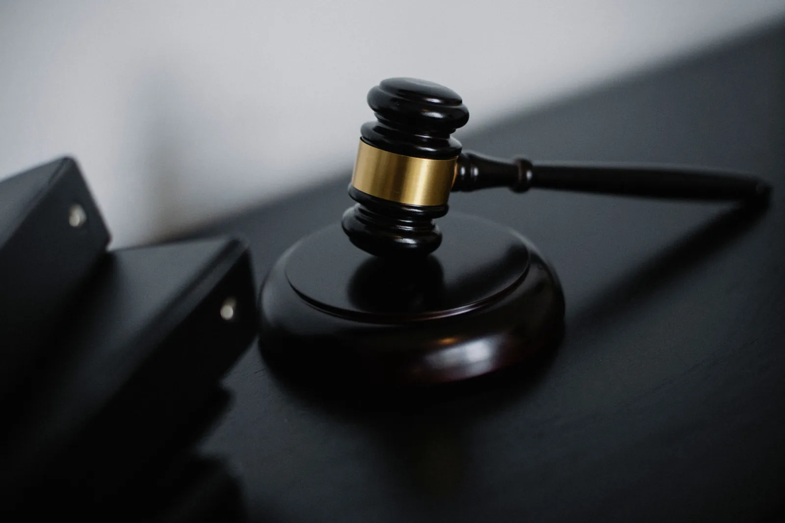Wooden gavel resting on its block on a desk.